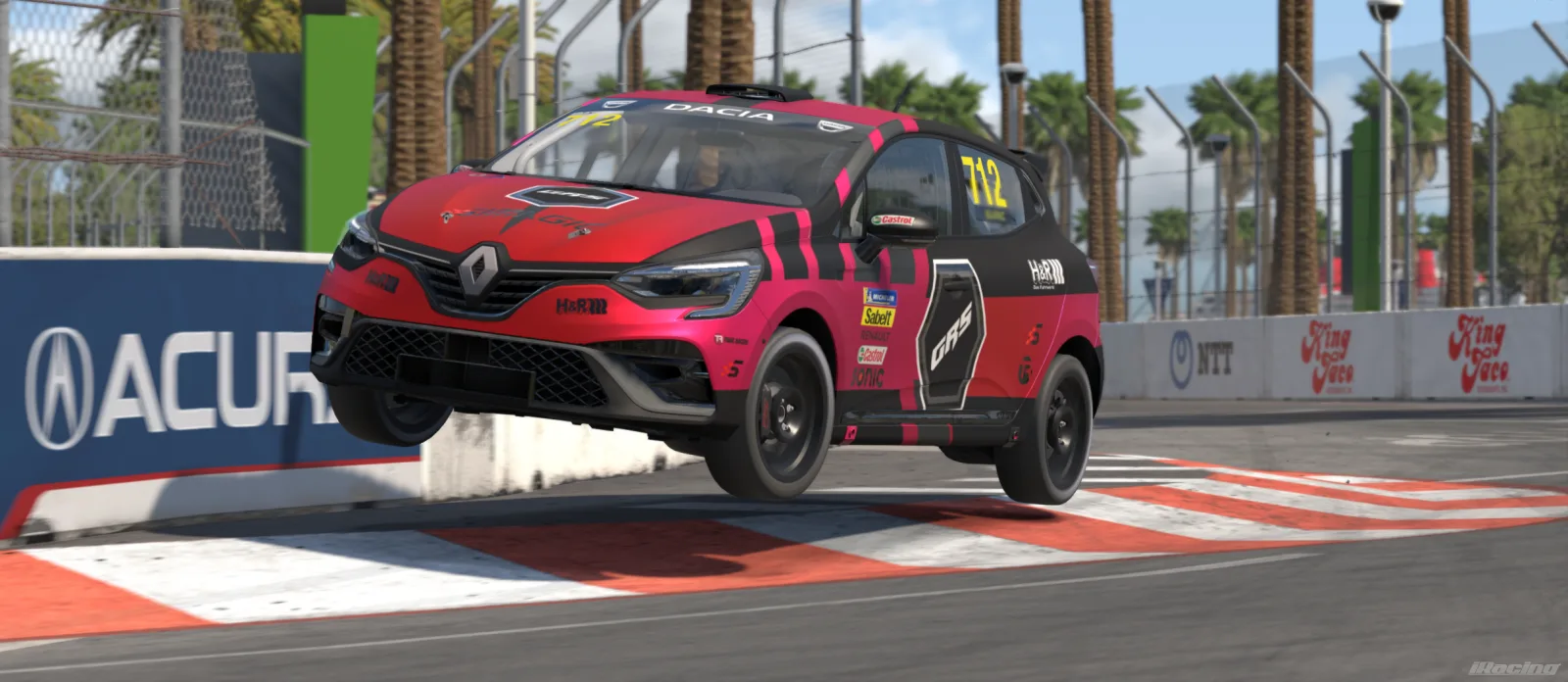Team GRS Renault Clio airborne in the new red livery